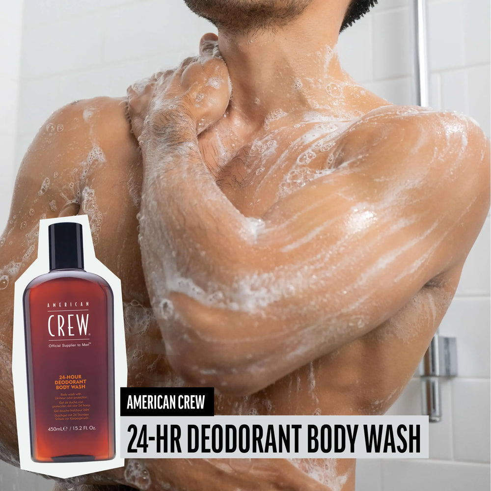 Man washingtorso with American Crew 24-Hour Deodorant Body Wash, chest and armas lathered and foamy, while product render and name are placed on the lower third of image.