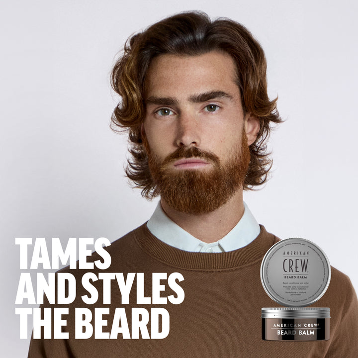 Model Pablo Sobrino is sporting a full beard, wearing a brown sweater with an overlay of American Crew Beard Balm next to the text "Tames and styles the beard". 