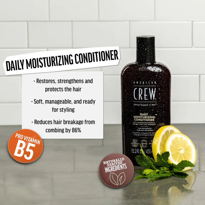 American Crew Daily Moisturizing Conditioner bottle with lemon and mint leaves on a tiled background. Text callout says "Restores, strengthens".  and protects the hair. Soft, manageable, and read for styling. Reduces hair breakage from combing by 86%."